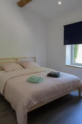 a bedroom with a bed with two towels on it at Domaine Le Piboul in Fontcouverte