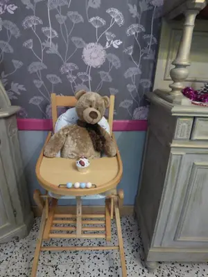 a teddy bear sitting in a chair in a room at Gîte les Hirondelles in Caudiès-de-Fenouillèdes