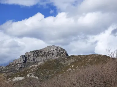 a mountain in the distance with a cloudy sky at Gîte les Hirondelles in Caudiès-de-Fenouillèdes
