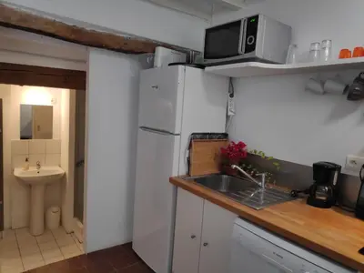 a kitchen with a sink and a white refrigerator at Fisherman's View in Bages