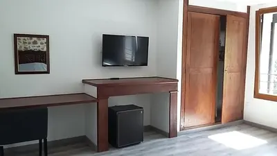 a room with a desk and a tv on a wall at Palais Cathare in Bélesta