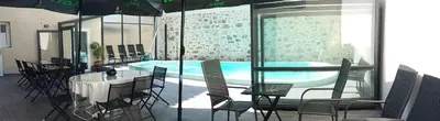 a room with a pool and a table and chairs at Palais Cathare in Bélesta
