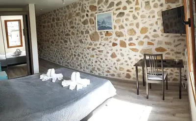 a bedroom with a bed and a table and a chair at Palais Cathare in Bélesta