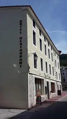 a white building with a sign on the side of it at Palais Cathare in Bélesta