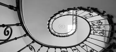 a spiral staircase with a mirror on it at Hôtel Restaurant de France in Castelnaudary