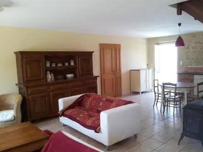 a living room with a white couch and a table at Jj French Gites in Pécharic-et-le-Py