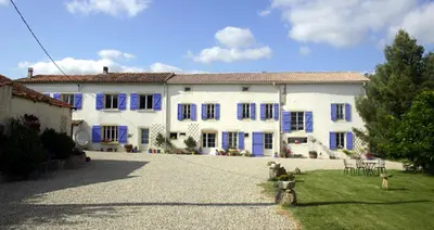 a large white house with blue shutters at Jj French Gites in Pécharic-et-le-Py