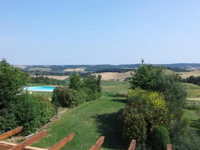 a view of a garden with a swimming pool at Jj French Gites in Pécharic-et-le-Py