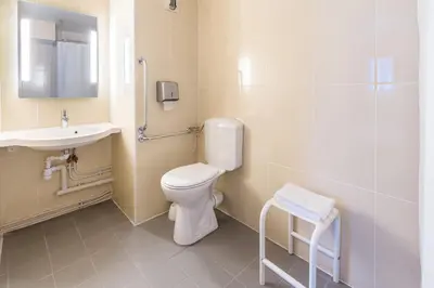 a bathroom with a toilet and a sink at B&B HOTEL Narbonne 1 in Narbonne