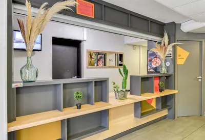 a room with shelves and potted plants at B&B HOTEL Narbonne 2 in Narbonne