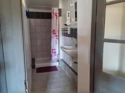 a bathroom with a sink and a shower curtain at Appartements Cote pont Vieux-Self Check-In in Carcassonne