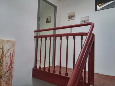 a staircase with a red railing in a room at Appartements Cote pont Vieux-Self Check-In in Carcassonne