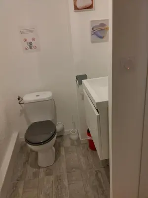 a bathroom with a toilet and a sink at Appartements Cote pont Vieux-Self Check-In in Carcassonne