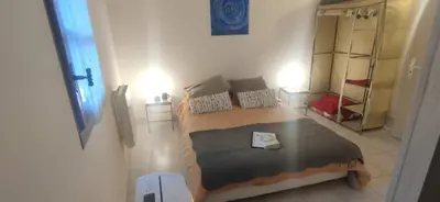 a small bedroom with a bed and a mirror at Appartements Cote pont Vieux-Self Check-In in Carcassonne