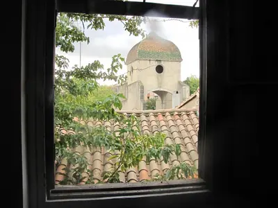 a window view of a building with a tower at Appartements Cote pont Vieux-Self Check-In in Carcassonne
