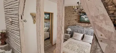 a small bedroom with a bed and a mirror at Château de Verdalle in Verdalle