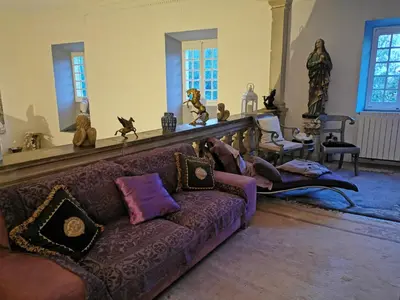 a living room with a couch with pillows at Château de Verdalle in Verdalle