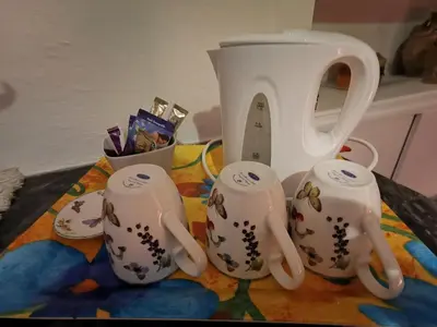 a tea pot and four teapots on a table at Château de Verdalle in Verdalle