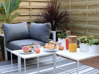 a table with food and drinks on it with a couch at Maison Bacou cité 3 in Carcassonne