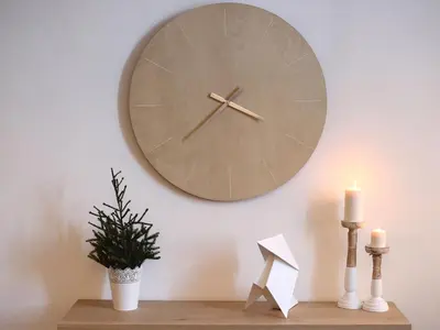 a clock on a wall with a plant and candles at Maison Bacou cité 3 in Carcassonne