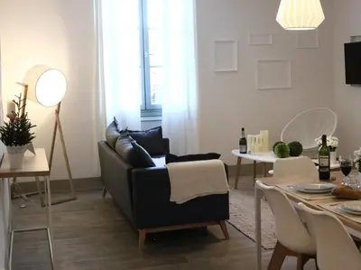 a living room with a couch and a table at Maison Bacou cité 3 in Carcassonne