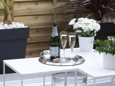 a bottle of champagne and two glasses on a table at Maison Bacou cité 3 in Carcassonne