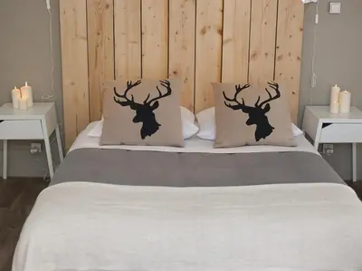 a bed with two deer head pillows on it at Maison Bacou cité 3 in Carcassonne