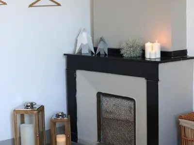 a fireplace with two candles on top of it at Maison Bacou cité 3 in Carcassonne