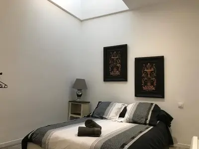 a bedroom with a bed with a teddy bear on it at Les Chambres du Palais in Carcassonne