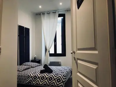 a bedroom with a bed and a window at Les Chambres du Palais in Carcassonne