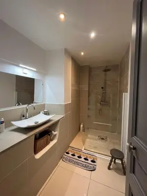 a bathroom with a shower and a sink and a tub at Les Chambres du Palais in Carcassonne