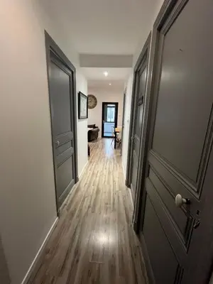 an empty hallway with an open door and a room at Les Chambres du Palais in Carcassonne