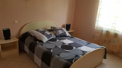 a bedroom with a bed with a checkered blanket at Nina in Carcassonne