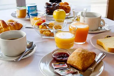 a table topped with plates of breakfast foods and drinks at Nina in Carcassonne