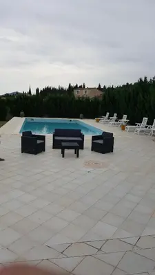 a swimming pool with lounge chairs and a swimming pool at Nina in Carcassonne