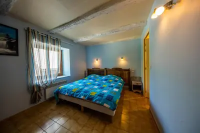 a bedroom with a bed in a room with a window at Gîte de Rouayras in Nages