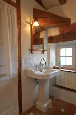 a bathroom with a sink and a mirror and a window at Cuq en Terrasses in Cuq-Toulza