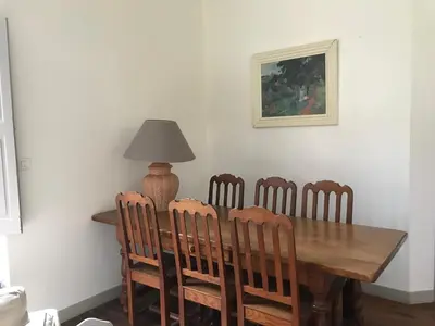 a dining room table with chairs and a lamp on it at Pavillon de Villefrancou in Montlaur