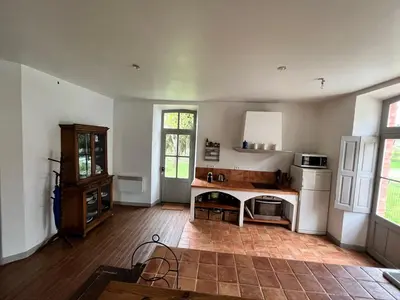 a large kitchen with a table in the middle at Pavillon de Villefrancou in Montlaur
