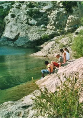 a group of children sitting on a hill by a river at Apartment the Haven in Cucugnan