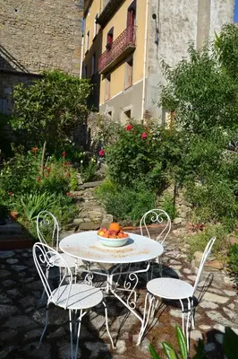 a table with two chairs and a bowl of oranges on it at Apartment the Haven in Cucugnan