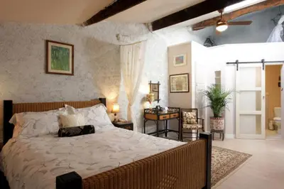 a bedroom with a large bed in a room at Maison de Textile Apartment in Montolieu
