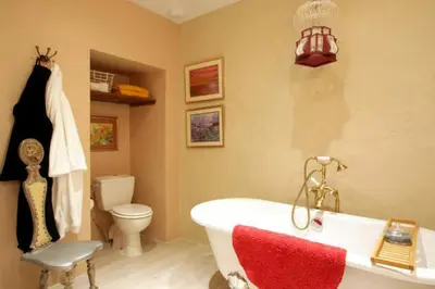 a bathroom with a white tub and a toilet at Maison de Textile Apartment in Montolieu