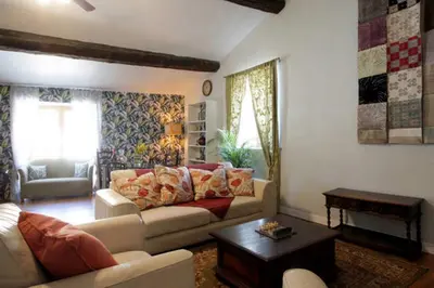 a living room with a couch and a table at Maison de Textile Apartment in Montolieu