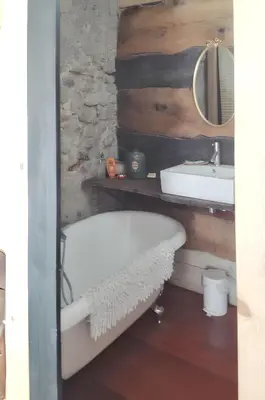 a bathroom with a bath tub and a sink at Maison de campagne avec vue sur la montagne à Puivert. in Puivert
