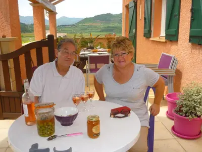 a man and woman sitting at a table with wine glasses at Le gite de Cristal proche Bugarach in Granès