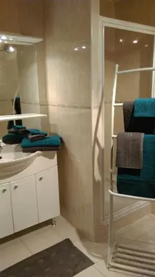 a bathroom with a sink and a shower with towels at Le Moulin de l'Abbé in Sorèze