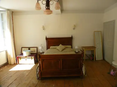 a bedroom with a wooden bed in a room at Nidélice Chambre d'hôtes in Quillan