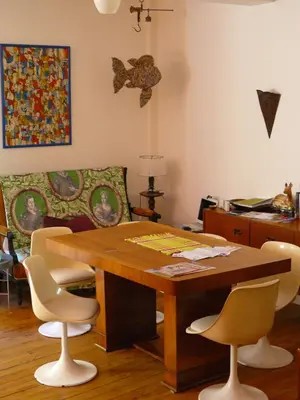 a dining room with a wooden table and chairs at Nidélice Chambre d'hôtes in Quillan