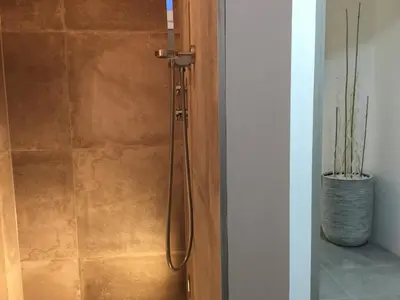 a shower in a bathroom with a glass door at LOFT SPA - Côté château. in Carcassonne